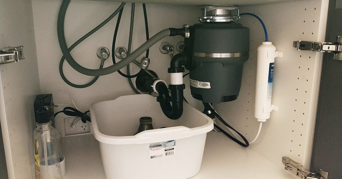 Under-sink drain and waste pipework below a kitchen sink