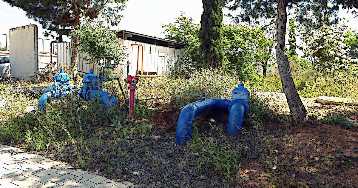 Exposed plumbing pipes showing bends and access around a service area