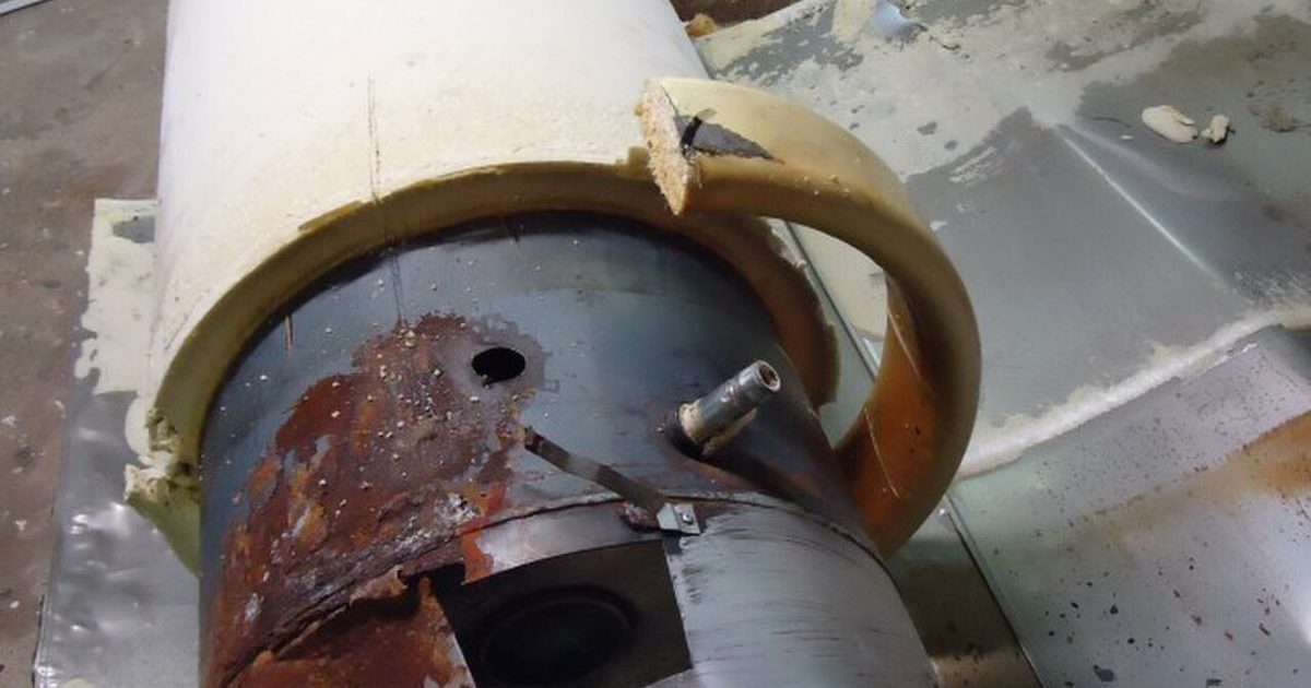 Older hot water heater tank showing worn internal parts