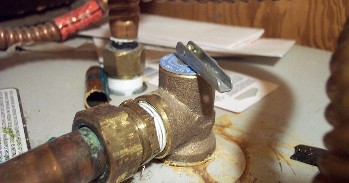 Close-up of a hot water system valve and copper pipe connection