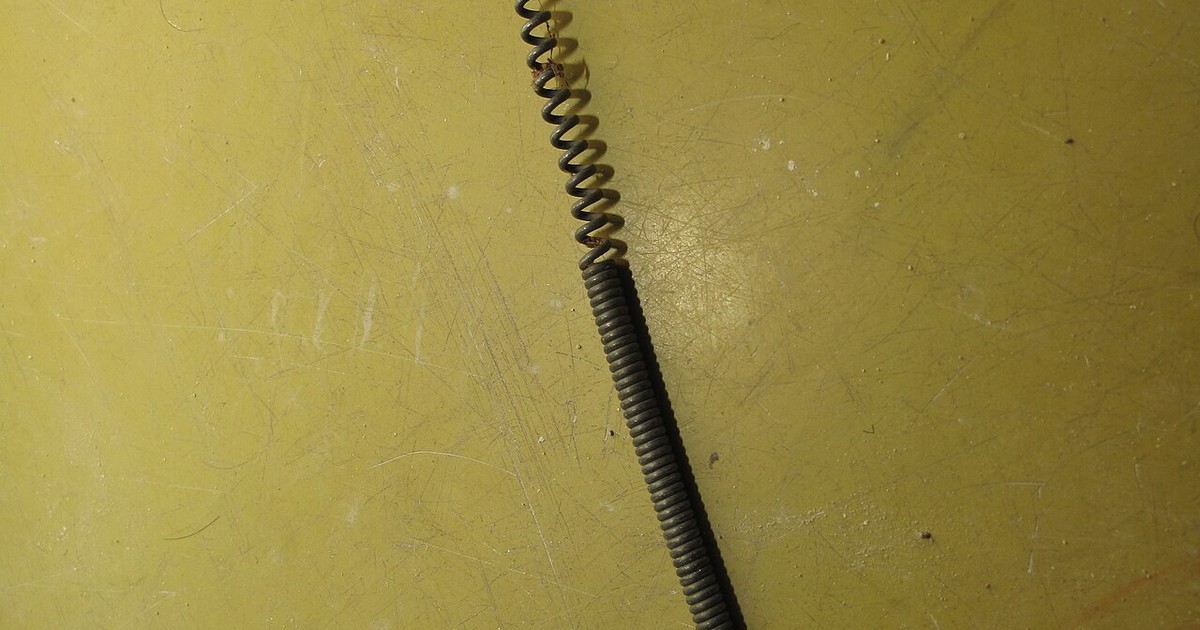 A drain-cleaning snake fed into a floor drain