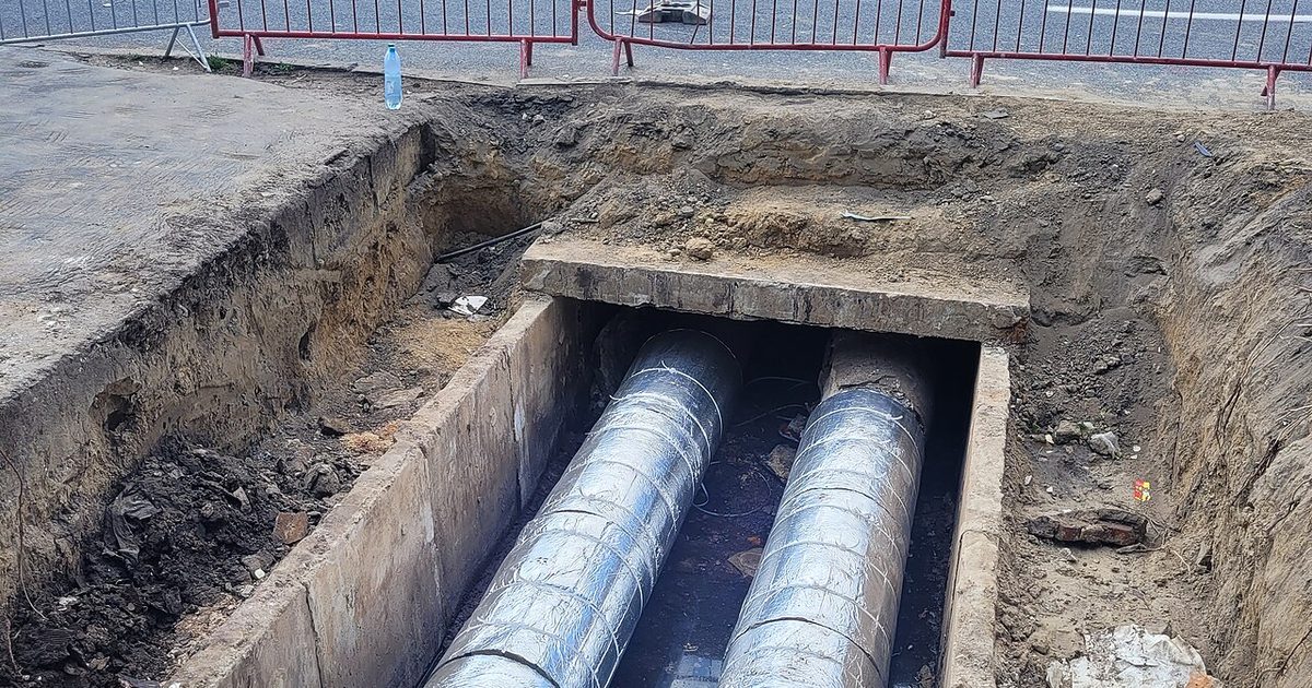 Exposed underground pipes in a trench during pipe repair