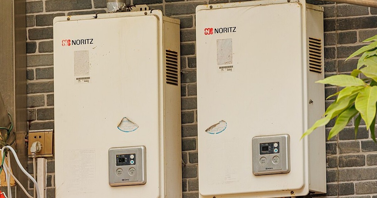 Continuous-flow hot water units mounted on an external brick wall
