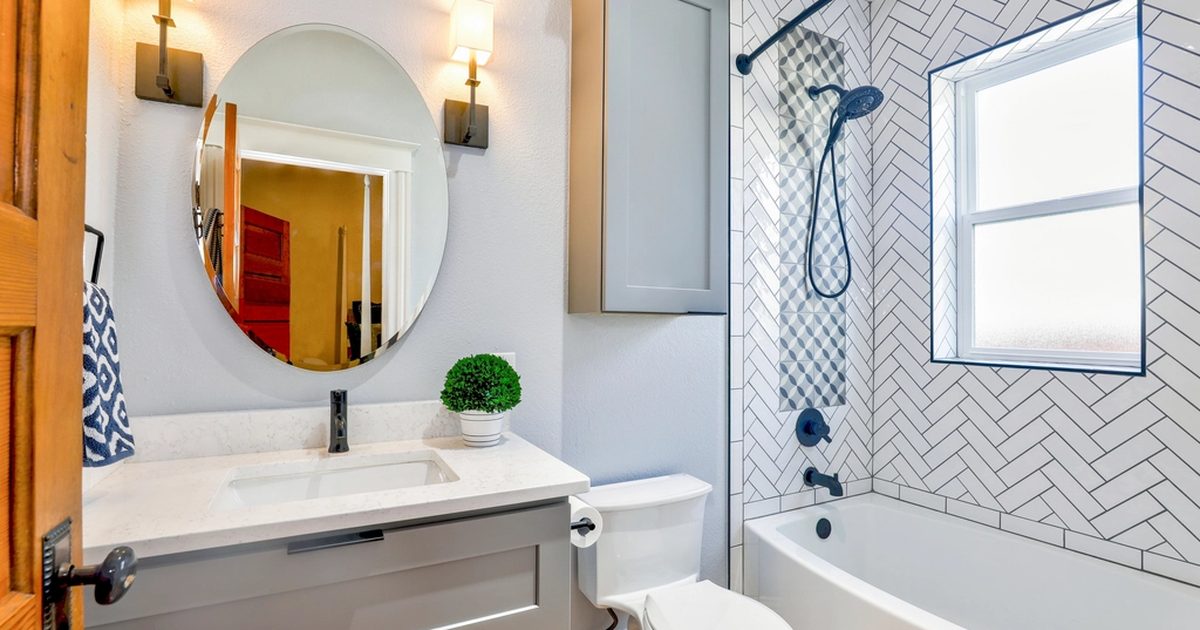 Clean bathroom with shower and sink where drain odours may appear